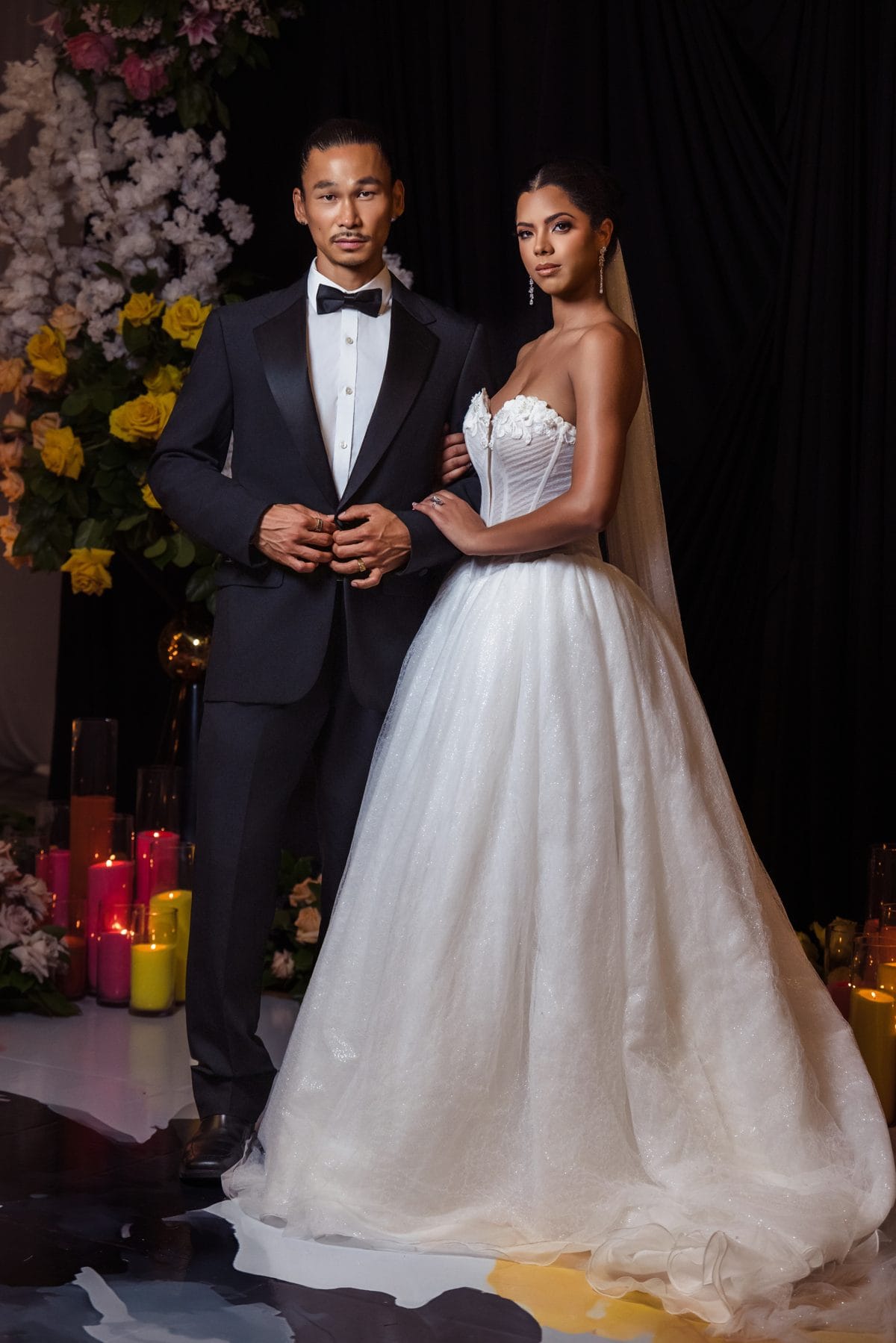 A luxury Atlanta wedding couple before an opulent floral backdrop, designed by Greystone Design Co.