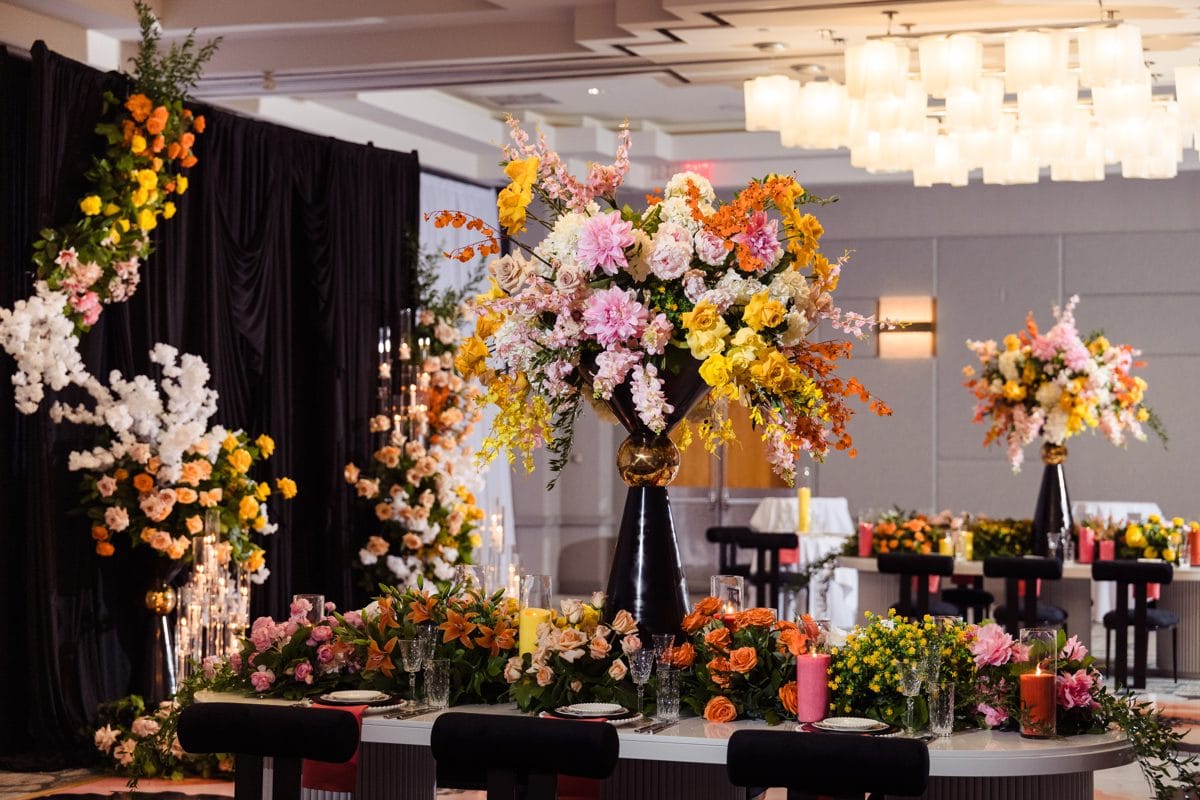 Luxury corporate gala reception with large-scale floral installations and dramatic staging produced by Greystone Design Co.