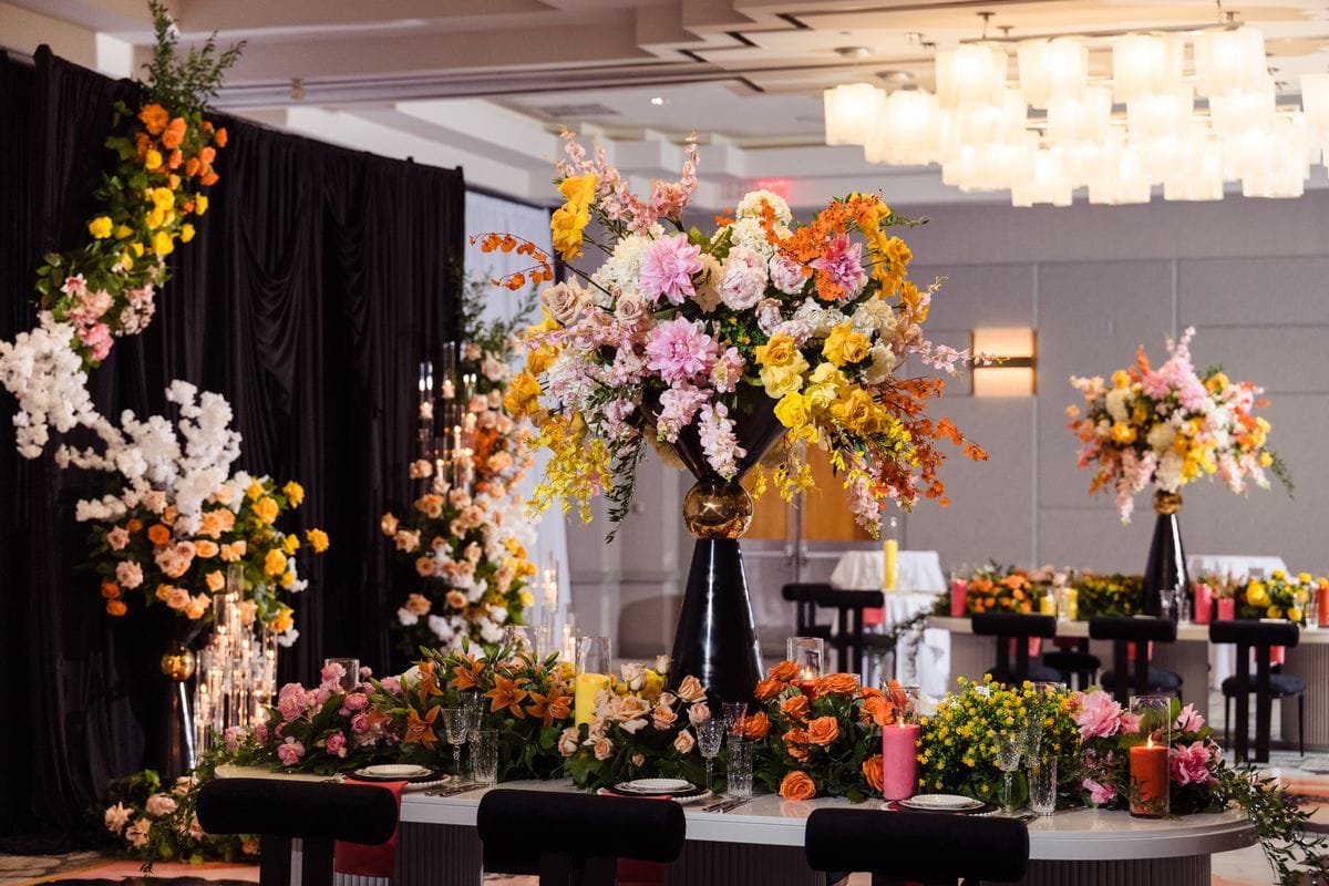 Large-scale ballroom reception concept with dramatic floral centerpieces
