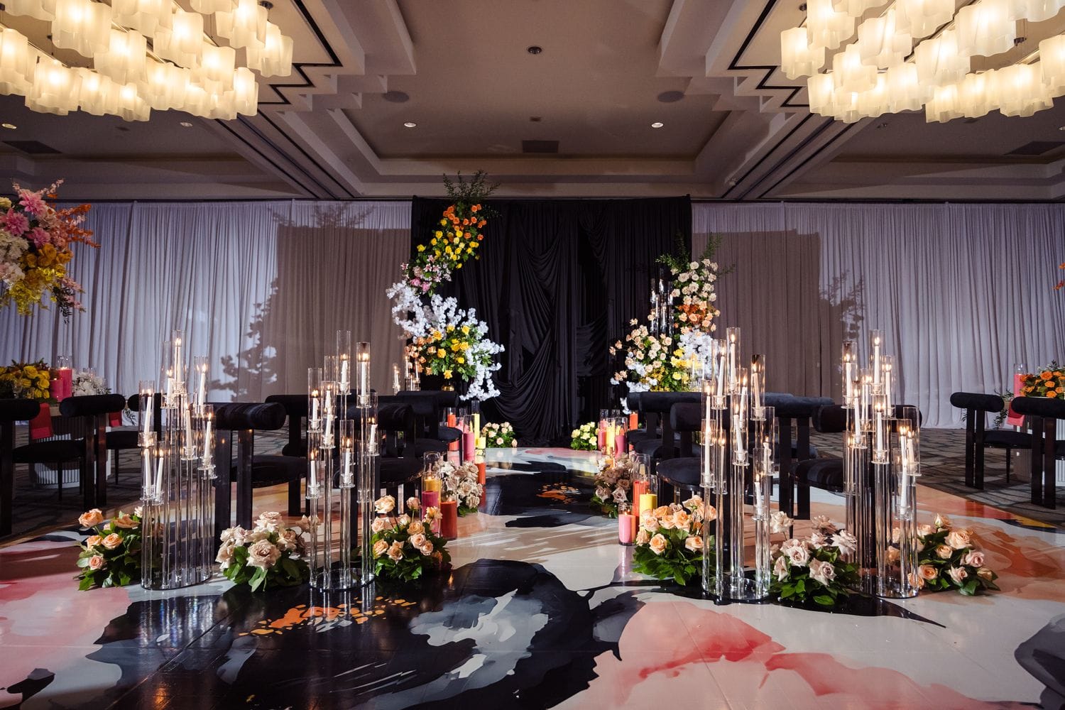 Luxury wedding ceremony with a candlelit aisle and floral backdrop designed by Greystone Design Co. in Atlanta, GA